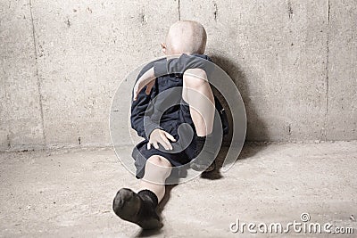 Neglected lonely child leaning at the wall Stock Photo