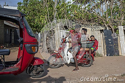 A father and son transporting a basket of dried fish at Negombo in Sri Lanka. Editorial Stock Photo