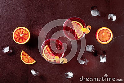 Negroni cocktails, toned image. Blood oranges, glasses with orange peel Stock Photo