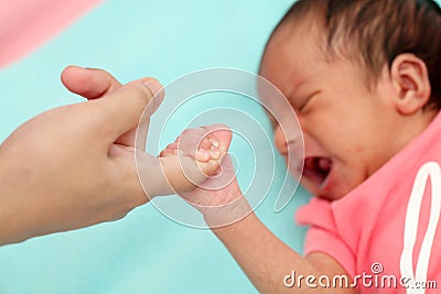 Newborn baby gripping mothers finger Stock Photo