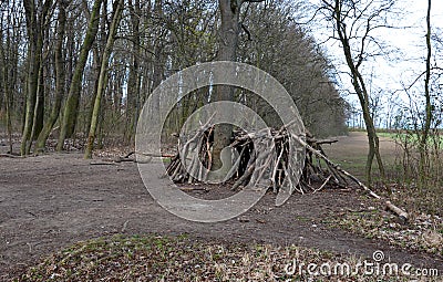 A Neolithic hut, a wooden building of ethnically backward nations, or a survival lodge. logs assembled in the shape of a yurt, ear Stock Photo