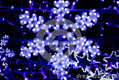 Neon, blue glowing snowflakes, colorful background, out of focus Stock Photo