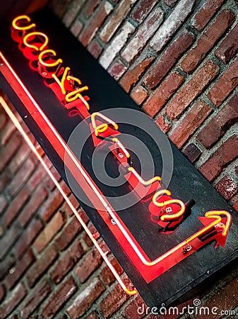 Neon cocktail sign on weathered brick Stock Photo