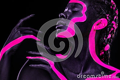 Neon colors. Pink and black body paint. Woman with face art. Young girl with colorful bodypaint. An amazing afro Stock Photo