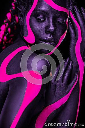 Neon colors. Pink and black body paint. Woman with face art. Young girl with colorful bodypaint. An amazing afro Stock Photo