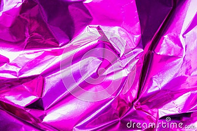 Neon crumpled holographic abstraction in bright pink and purple, selective focus, blur Stock Photo