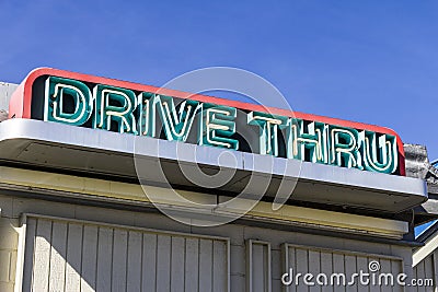 Neon Drive Thru Sign at a Fast Food Restaurant I Stock Photo