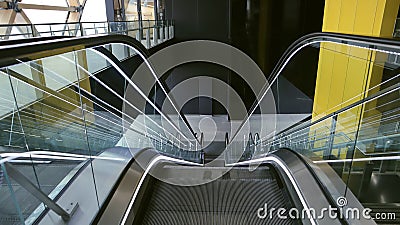 Neon illuminated metal excalator, stairs view descent down to floor Stock Photo
