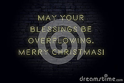 Neon inscription of christmas and new year greetings on brick wall Stock Photo