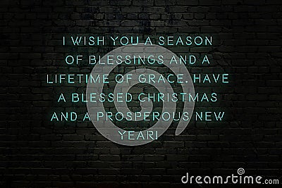 Neon inscription of christmas and new year greetings on brick wall Stock Photo