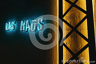 Neon luminous sign `Das Haus` in architecture Stock Photo
