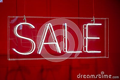 Neon sale sign sparkling in a red shop-window Stock Photo