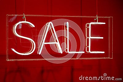 Neon sale sign sparkling in a red shop-window Stock Photo