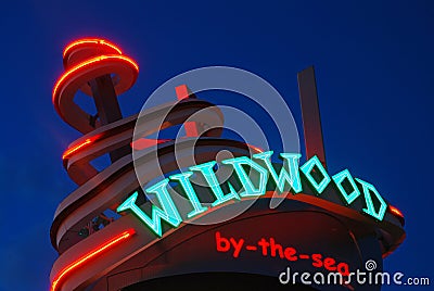 A neon sign glows at dusk in Wildwood, New Jersey Editorial Stock Photo