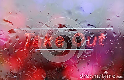 Neon Take Out Sign in Wet Rainy Window Stock Photo