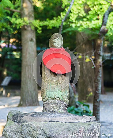 Neophyte stone statue red scarf stand Stock Photo