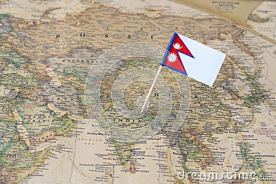 Nepal flag pin on a world map Stock Photo