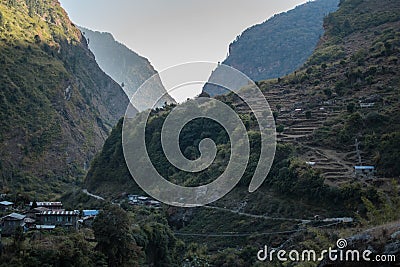 Nepalese mountain village with rice plantation terraces over the Marshyangdi river Stock Photo