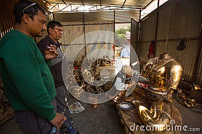 Nepalese tinman working in the his workshop, in Bhaktapur, Nepal. Editorial Stock Photo