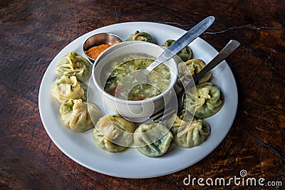 Nepalese traditional dumpling momos served with tomato chatni Stock Photo