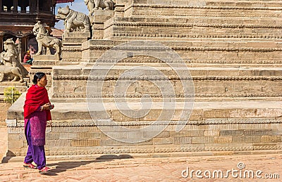 Nepalese woman walking by the Siddhi Laxmi Temple in Bhaktapur Editorial Stock Photo