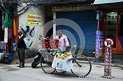 Nepali man vendor push bicycle cart hawker on road sale variety fruits and food to nepalese people and foreign travelers eat drink Editorial Stock Photo