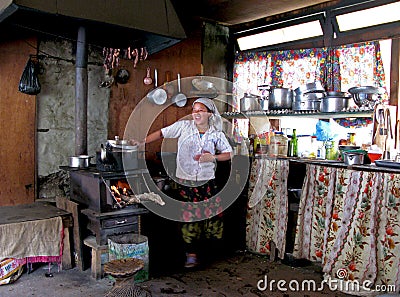 Nepali Woman cooking in her Himalayan Lodge Editorial Stock Photo