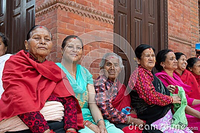 Nepali woman sitting in the city center of Bhaktapur Editorial Stock Photo