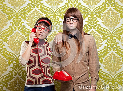 Nerd humor couple talking vintage red phone Stock Photo