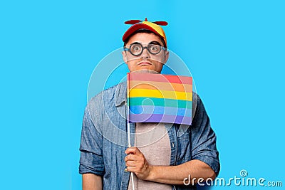 Nerd man with noob hat holding a rainbow flag Stock Photo
