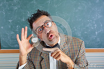Nerd silly teacher showing vintage chain watch Stock Photo