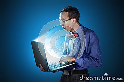 Nerdy man with laptop use standing position Stock Photo