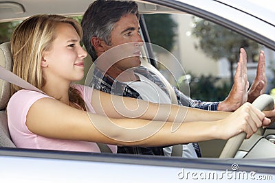 Nervous Father Teaching Teenage Daughter To Drive Stock Photo