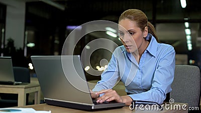 Nervous female working on laptop at night, stressful job causing health problems Stock Photo