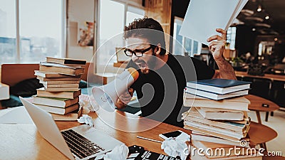 Nervous Freelance Writer Shouting into Megaphone Stock Photo