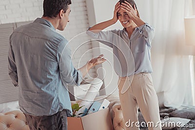 Nervous husband finding fault with his crying wife Stock Photo