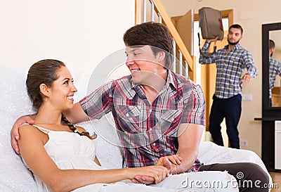 Nervous husband watching flirting spouse Stock Photo