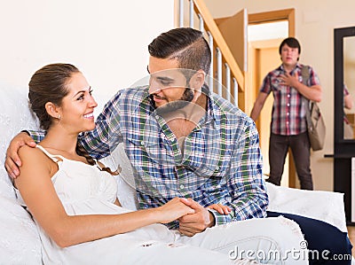 Nervous husband watching flirting spouse Stock Photo