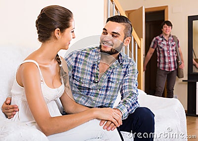 Nervous husband watching flirting spouse Stock Photo