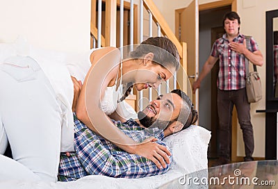 Nervous husband watching flirting spouse Stock Photo