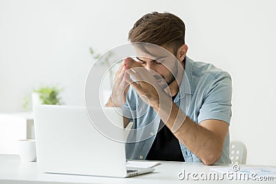 Nervous man thinking over problem trying to focus at work Stock Photo