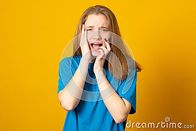 Nervous puzzled woman grabs head, has terrible pain, suffers from migraine, expresses desperate emotions, realizes something very Stock Photo