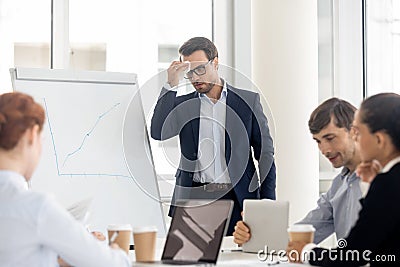 Nervous sweaty public speaker sweating wiping sweat afraid or speaking Stock Photo