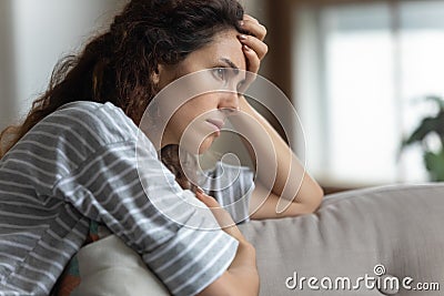 Nervous woman looking away, lost in thoughts alone at home. Stock Photo