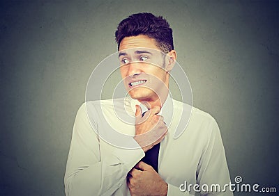 Nervous young man feels awkward looking away anxiously Stock Photo