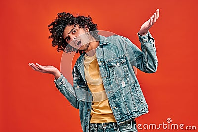 Confused eastern curly student shrugs Stock Photo