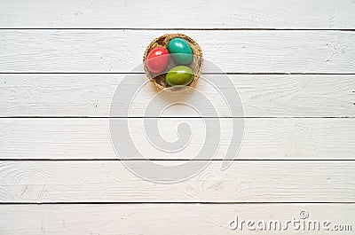 Nest colored eggs wreath on white wooden planks background Stock Photo