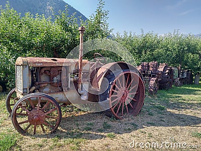 Old Rusted vintage tractor in a field Stock Photo