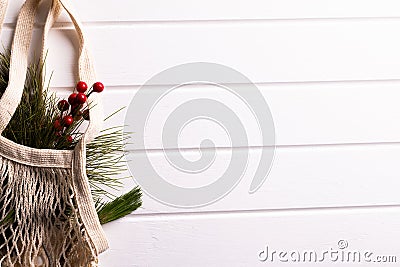 Net bag with chrsitmas decorations, fir tree branches, copy space on white background Stock Photo