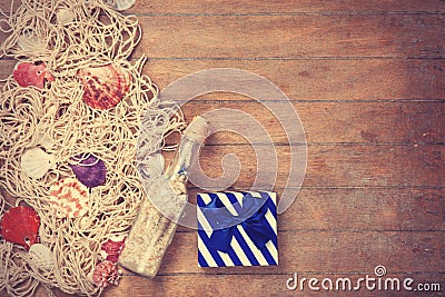 Net, gift and shells with bottle Stock Photo